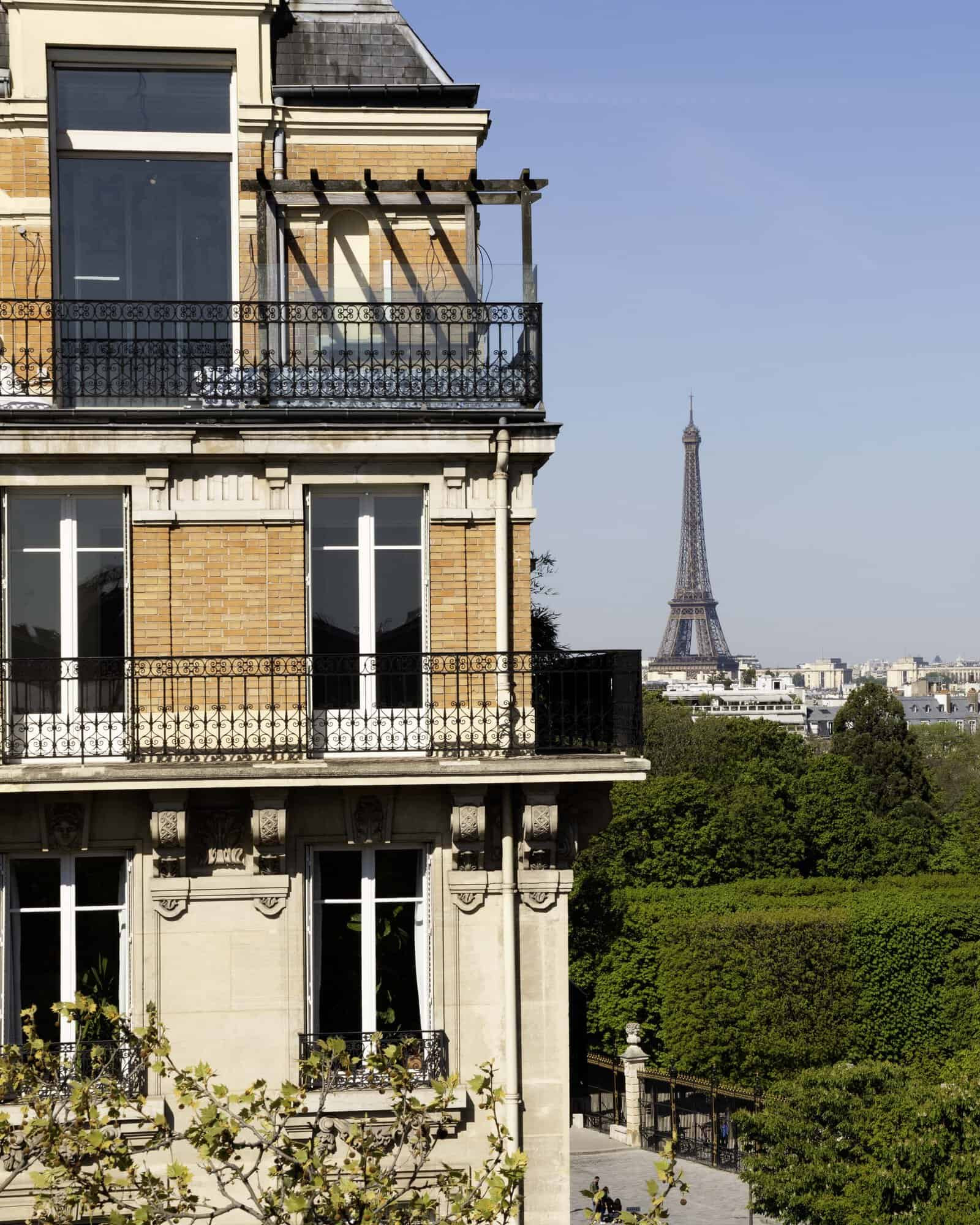 Building next to the Luxembourg Gardens with the Eiffel Tower in the background.